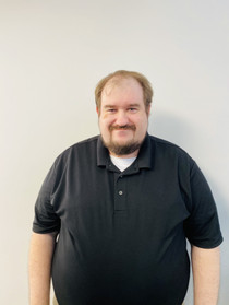 A man with a beard and mustache wearing a black shirt.